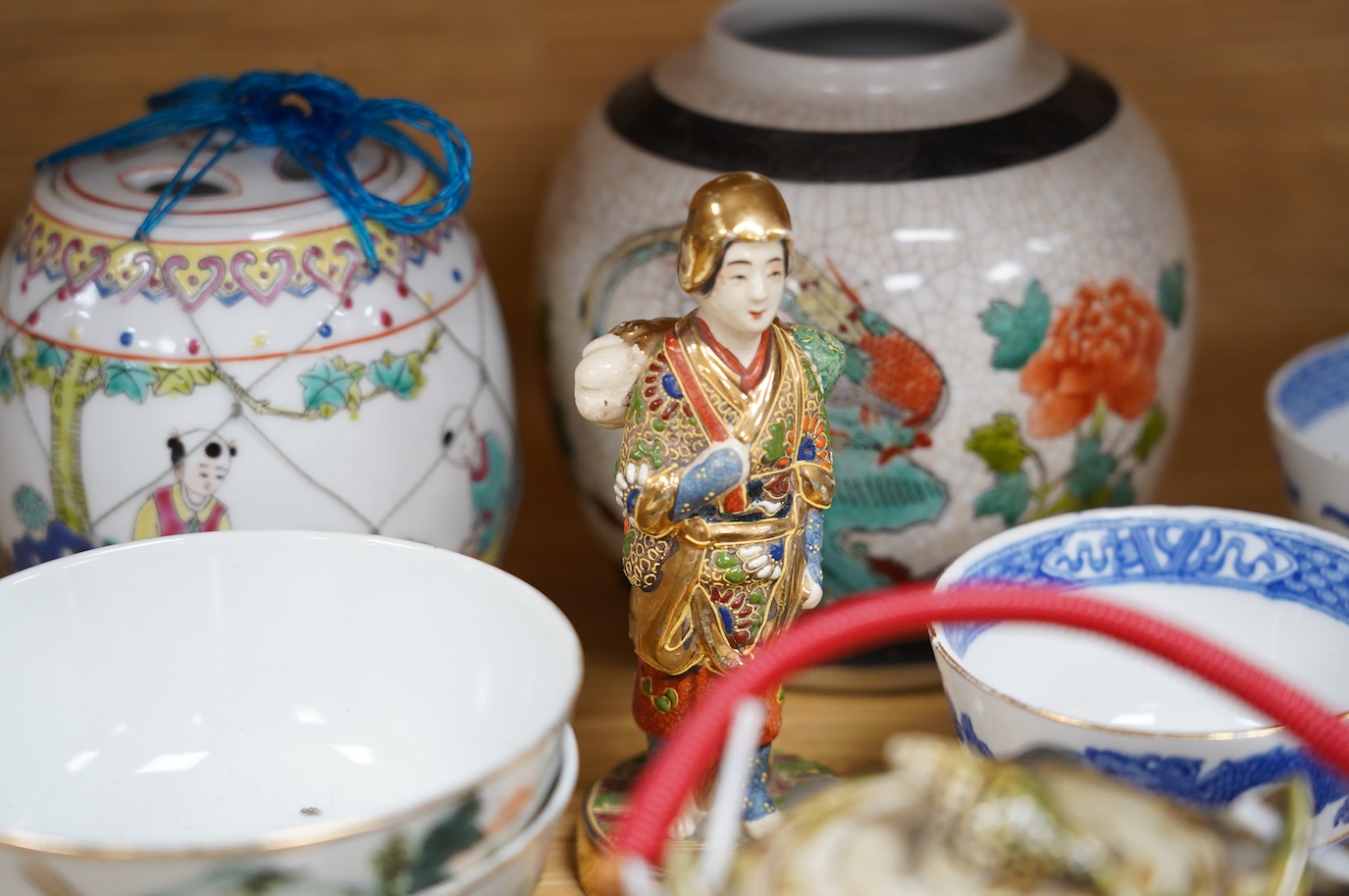 A collection of Chinese and Japanese ceramics to include tea bowls, a blue and white mug and teapot in the form of a shell, largest 13cm high. Condition - mostly good